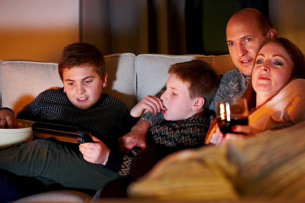 istock Caucasian family watching television 472617912