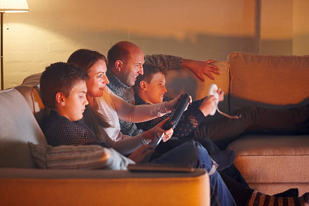 istock Happy family having fun playing video games 472617916