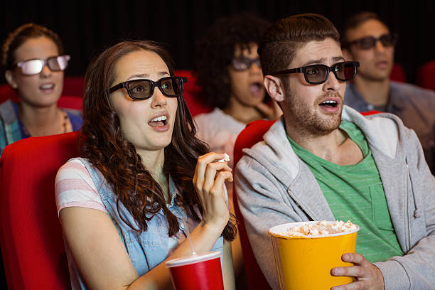istock Young friends watching a 3d film 472618038