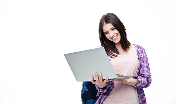 istock Happy young woman standing with laptop 472618228