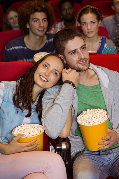 istock Young people watching a film 472619180