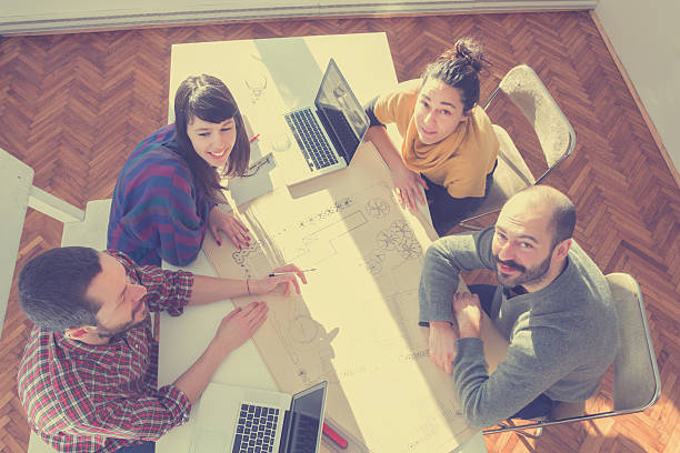istock Young group of people/architects discussing business plans 472619246