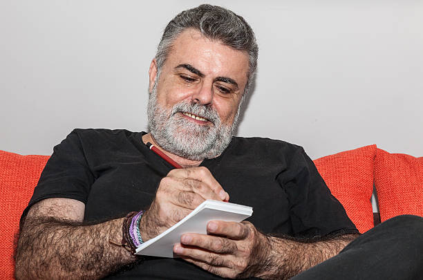 istock Attractive Senior with white beard smoking electronic cigarette 472620234