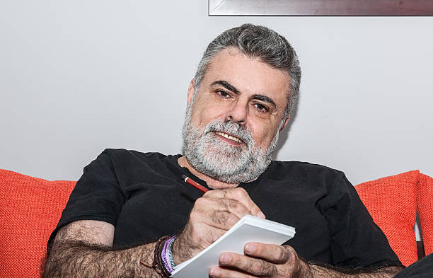 istock Attractive Senior with white beard smoking electronic cigarette 472620356