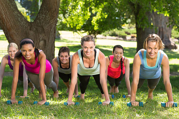 istock Fitness group planking in park 472623390