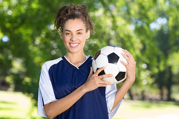 Female football players huddling together