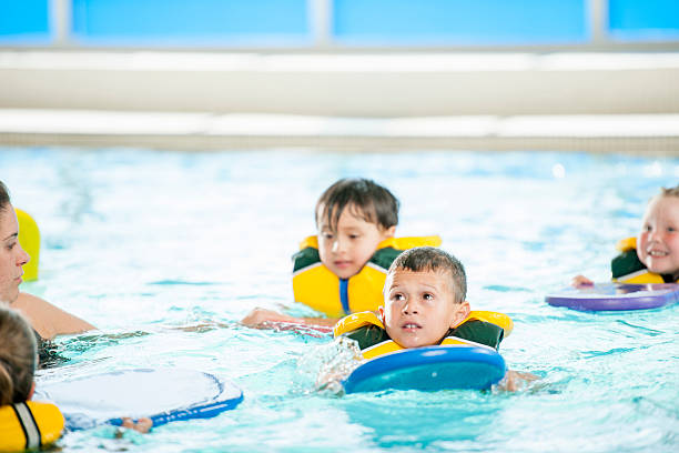 istock Children Swimming with Kick Boards 472623778