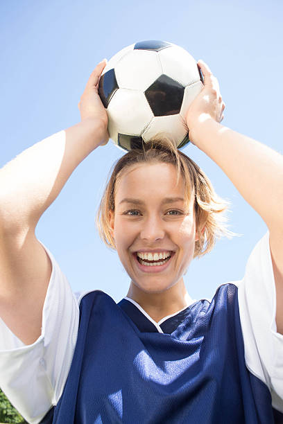istock Pretty football player smiling at camera 472623934