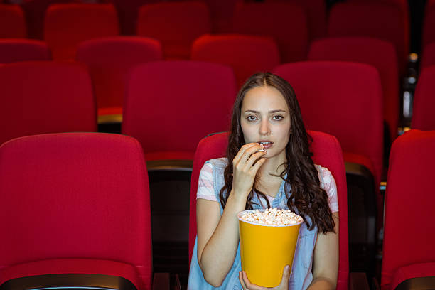 istock Young woman watching a film 472625372