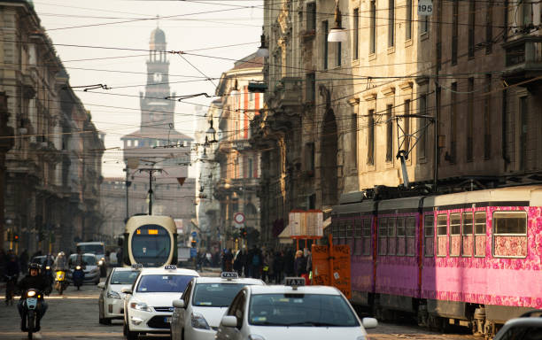 Milan Streets. Via Orefici. Castle Square. Milan, Italy - February 23, 2011: Via Orefici street in Milan centre during the city rush hours with busy road with taxis and trams. In the background Castello Sforzesco fort. Castello Sforzesco is a huge Medieval-Renaissance fortress with historical museums image created 21st century multi colored arrangement outdoors stock pictures, royalty-free photos & images