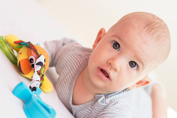 istock Baby boy is playing with a toy 472625848