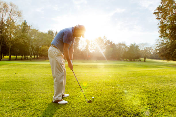 Male golfer teeing off Male golfer teeing off golf concentration stock pictures, royalty-free photos & images