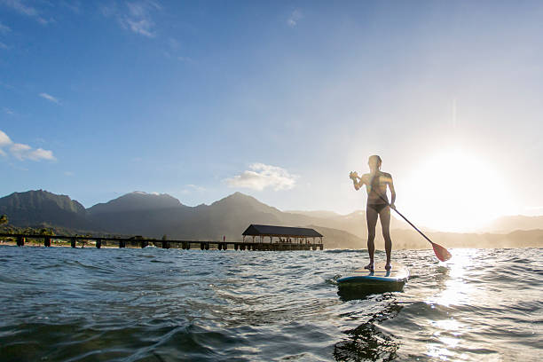 istock Silhoutte of Woman Paddle Boarding 472629094