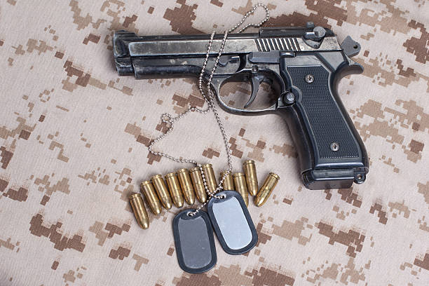 istock Beretta hand gun on  desert marines uniform 472629276