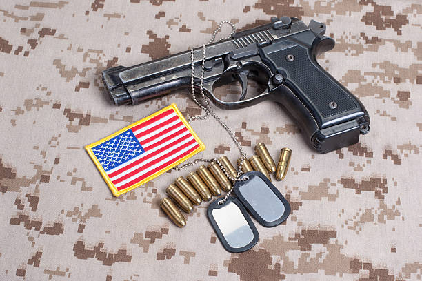 istock Beretta hand gun on  desert marines uniform 472629280