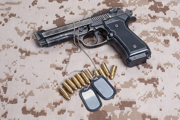 istock Beretta hand gun on  desert marines uniform 472629292