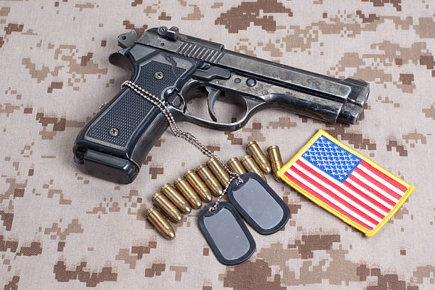 istock Beretta hand gun on  desert marines uniform 472629304