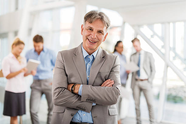 istock Happy mature CEO with his arms crossed looking at camera. 472630962