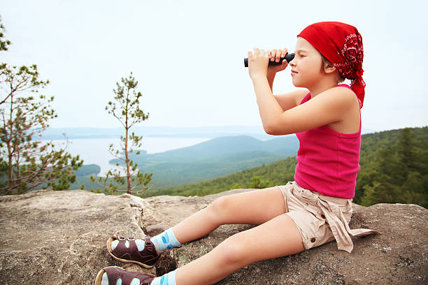 istock Girl with spyglass 472636232