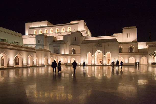 Opera House in Muscat, Oman, in the evening. Reflection on the tiles. Modern Arabian style architecture.