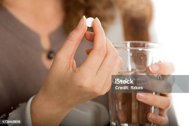 Female Hands Hold Pill And Glass Of Water Stock Photo - Download Image Now - Medicine, Pill, Capsule - Medicine