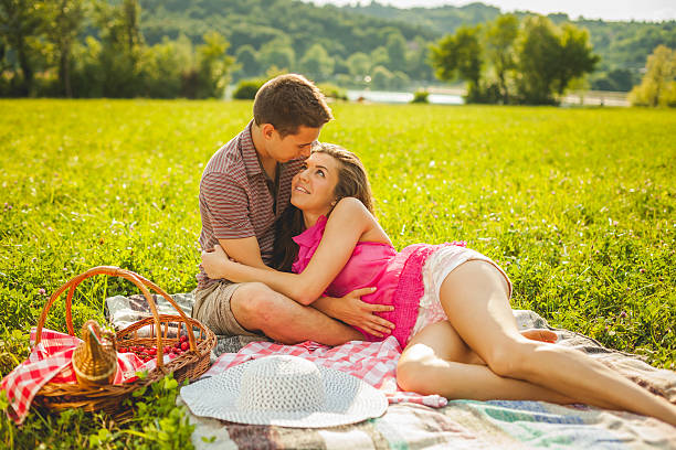 istock Happy young couple on a picnic 472644992