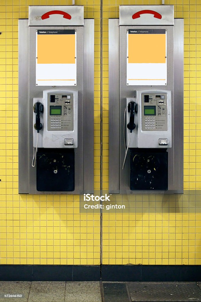 Payphones in the tunnel Two old nostalgic payphones hanging on the tiled wall of a subway tunnel. 2015 Stock Photo