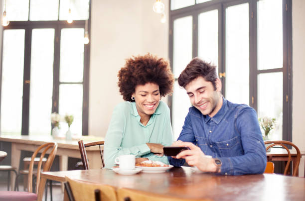 istock Couple looking at cellphone 472647130