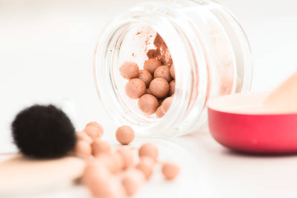 istock bronzing pearls in jar and makeup brush 472647986