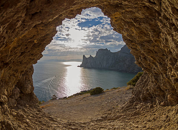 istock View of the sea from a small rock grotto. 472654850