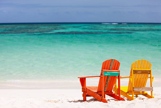 istock Colorful lounge chairs at Caribbean beach 472654930
