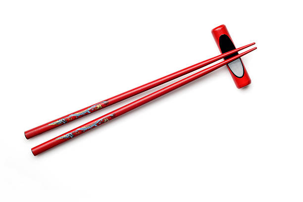 istock Red Wooden Chopsticks with Chopstick Rest Isolated on White Background 472658210