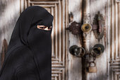 A mysterious Middle Eastern woman wearing a black Niqab