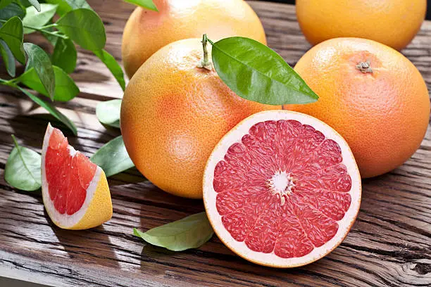 Grapefruits on a wooden table.
