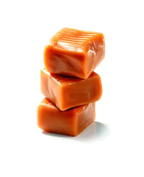 Photo of stack of toffee caramel candy close-up isolated
