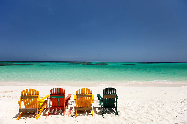 istock Colorful chairs on Caribbean beach 472659626