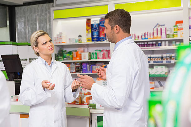 istock Team of pharmacist talking together 472659742