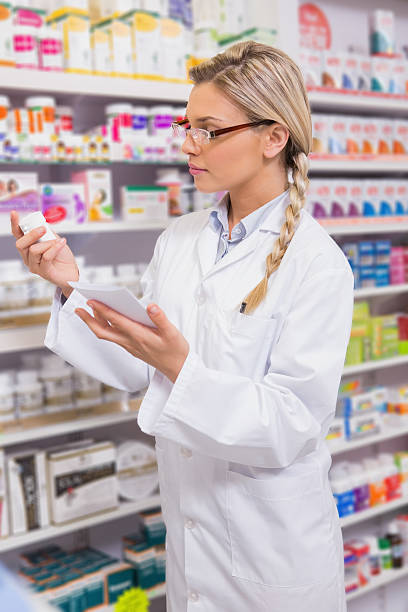 istock Student looking at prescription and medicine 472660792