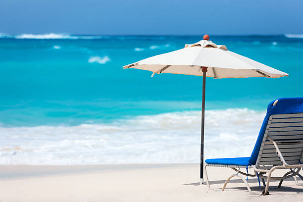 istock Chairs and umbrella on tropical beach 472662248