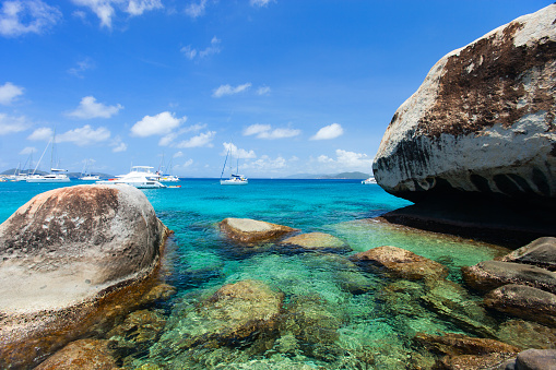 Stunning beach with white sand, unique huge granite boulders, turquoise ocean water and blue sky at Virgin Gorda, British Virgin Islands in Caribbean