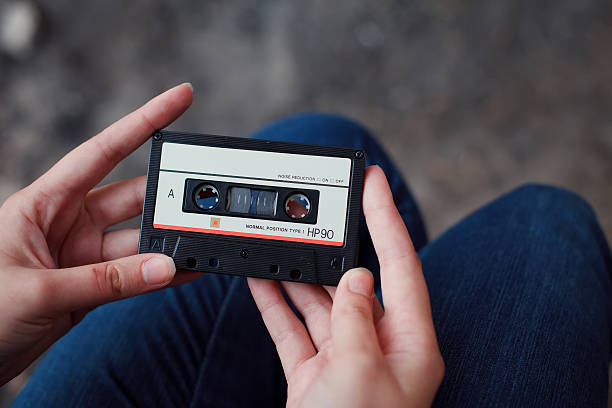 istock Beautiful girl with a cassette in her hands 472665364