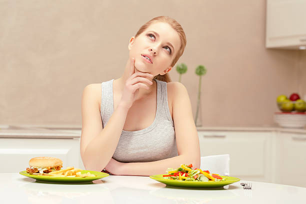 istock Young woman choosing lunch 472674086