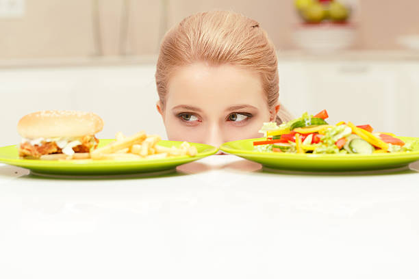istock Young woman choosing lunch 472674530
