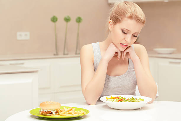 istock Young woman choosing lunch 472675946