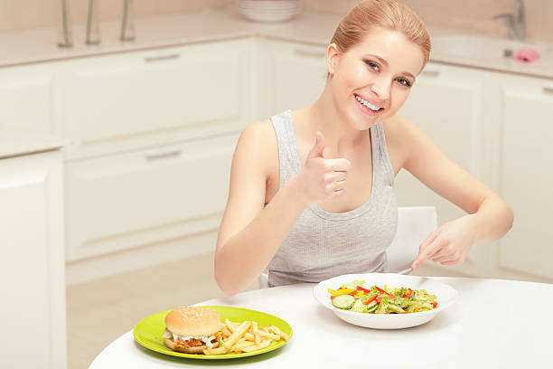istock Young woman choosing lunch 472675950