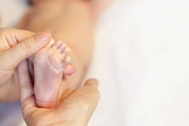 istock Mother makes massage for happy baby 472678010