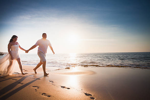 istock honeymooners couple just married running at beach 472678426