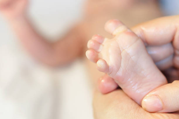istock Mother makes massage for happy baby 472678488