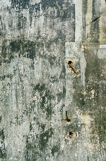 istock cracked painting stone wall background 472679376