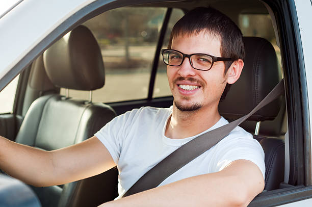 Male european good driver is smiling in his car stock photo